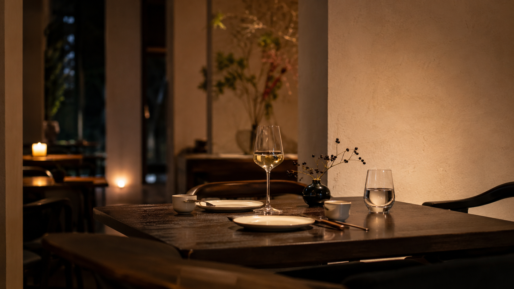 A small restaurant table near a gallery, prepared before dinner service.