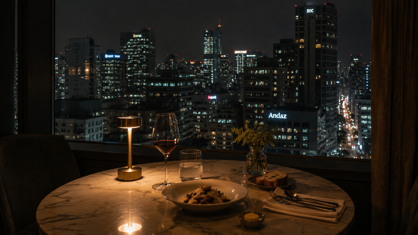 A late dining table near a hotel window at night.